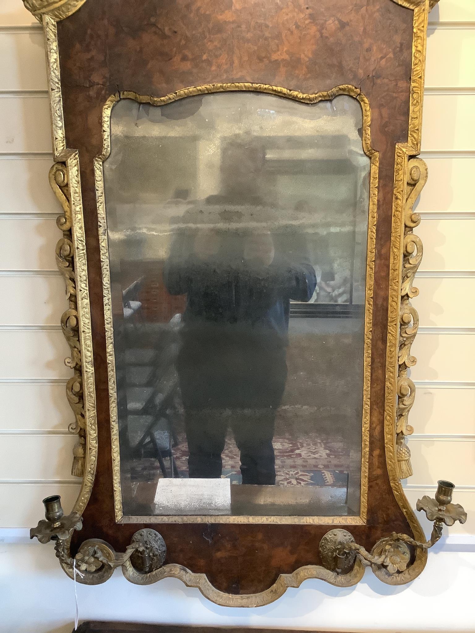 A George II and later carved giltwood and burr walnut wall mirror, 133.5cm high, 69cm wide